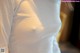 A close up of a woman's breast in a white shirt.