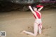 A woman in a red and white bathing suit on the beach.